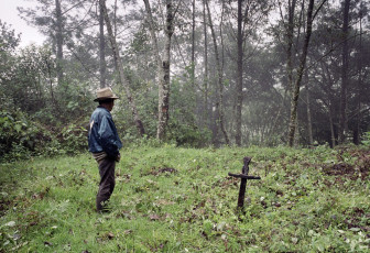 Samuel surveys the area in the forest where he had buried his four children, two who were killed by the army and two who died of hunger and illness while they were in hiding in these mountains fifteen years earlier. Nebaj, 2000