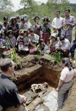 A prayer during the exhumation of a man killed and buried here by the guerillas in 1983. Nebaj, 2000