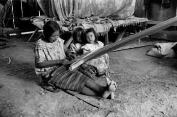 A Maya-Mam woman uses a traditional back strap loom to weave a huipil, a traditional blouse. These are former refugees who have recently returned to Guatemala from their twelve-year forced exile in camps across the border in the Mexican state of Chiapas. Ixtahuacán Chiquito, Ixcán, 1997