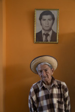 Jorge Noriega, with a photograph of his son, Jesús, one of nine men who were disappeared and then killed in 1992 by the Grupo Colina, a death squad that operated during the government of Alberto Fujimori. Santa, Ancash Region, 2013