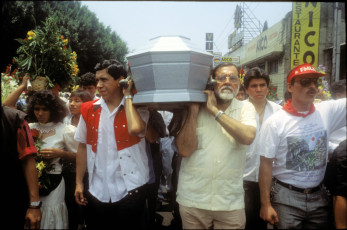 Commanders Joaquín Villalobos and Shafik Handal of the recently demobilized guerrilla coalition, the Farabundo Marti Front for National Liberation, carry the coffin containing the body of a young ex-combatant of the FMLN who was killed by the National Police during a demonstration. San Salvador, El Salvador, 1993