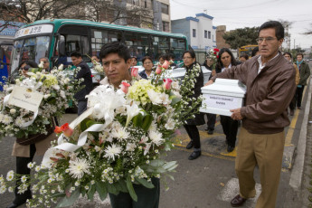 After the remains were handed over in the EPAF office, family members of some of the victims of the Parcco-Pomatambo massacre carry the coffins along a street in the Jesús María district in Lima. 2013