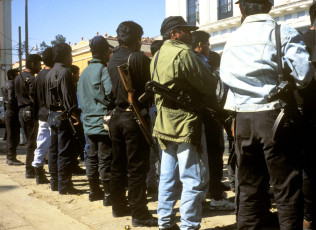 Police and members of a paramilitary force in the center of San Cristóbal de las Casas. Two years earlier, the Zapatista National Liberation Army briefly occupied this city and seven other municipal centers in Chiapas State, the same day that the North American Free Trade Agreement went into effect. Chiapas, México, 1996