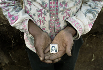 Domingo holds a photograph of his father, massacred in 1982. Nebaj, 2000