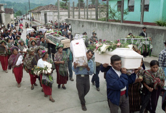 After the mass in the Church, relatives and supporters carry the remains of 121 people who had been massacred in the 1980s through the streets of Nebaj. 2001