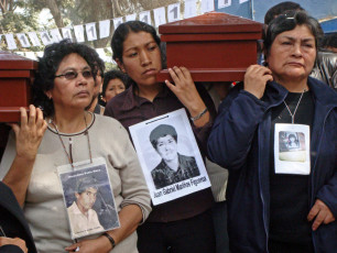 During a commemorative march on the sixteenth anniversary of the La Cantuta massacre, family of the nine students and one professor who were kidnapped and then executed, carry coffins containing the remains of their loved ones. The massacre took place during the presidency of Alberto Fujimori. Lima, July 18, 2008