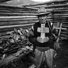 Nicolás, a Mayan priest, holds a cross that lists the ages of his seven massacred relatives. CPR of the Sierra, 1993